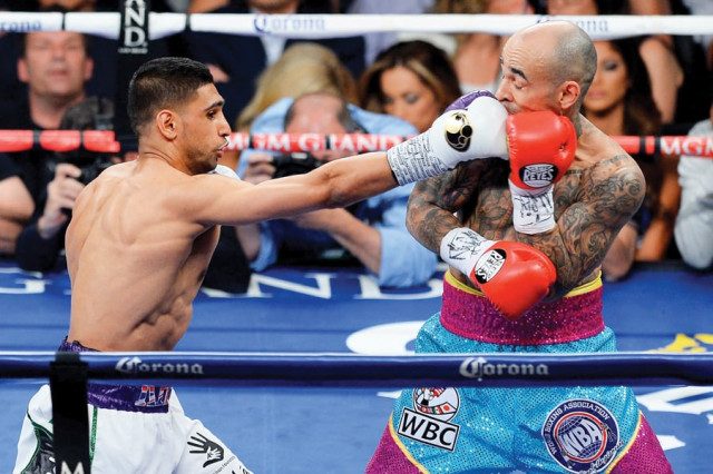 amir khan made a perfect start in the welterweight division as he convincingly defeated luis collazo in las vegas on saturday photo afp amir khan made a perfect start in the welterweight division as he convincingly defeated luis collazo in las vegas on saturday photo afp