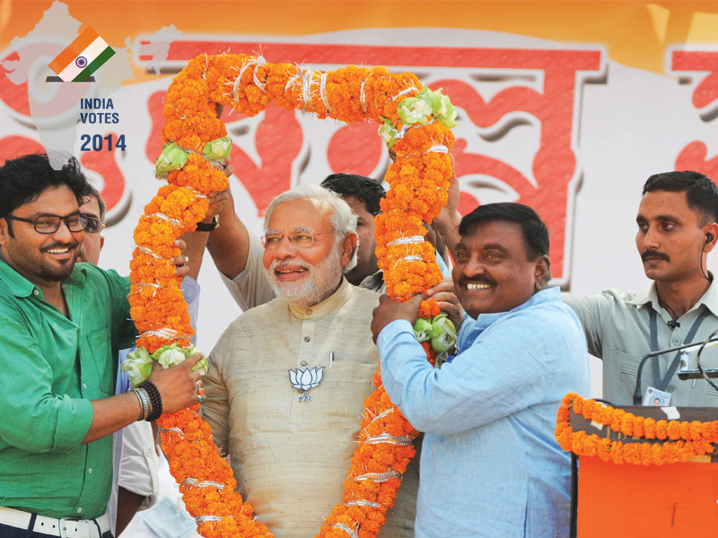 bjp prime ministerial candidate narendra modi is garlanded by asansole bjp candidate and bollywood singer babul supriya photo afp