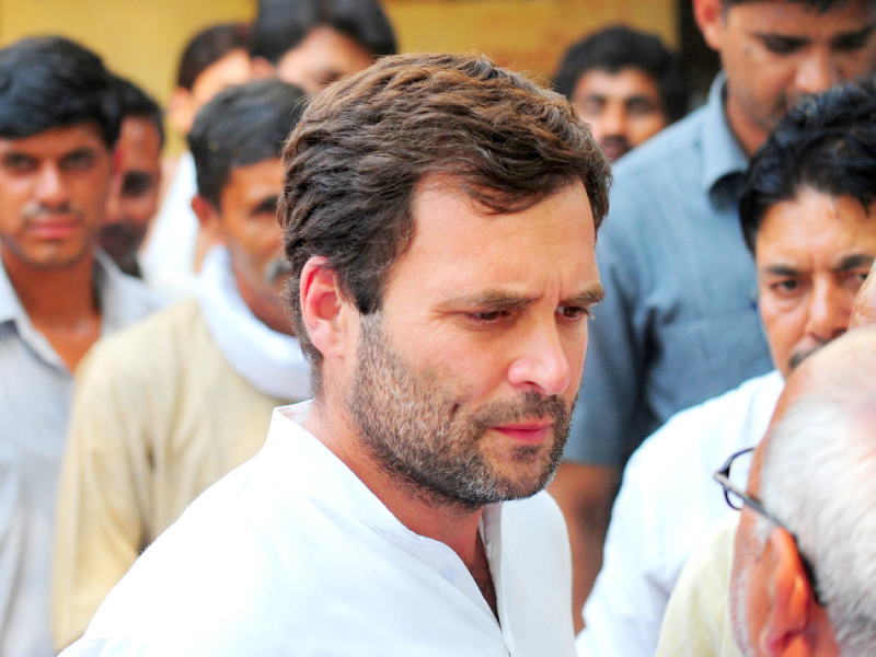 rahul gandhi speaks with residents near a polling station during voting in amethi photo afp