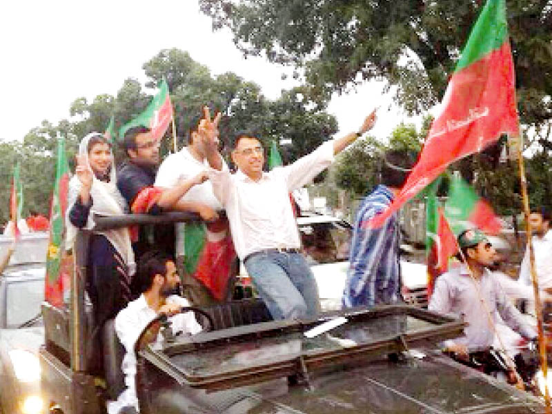 islamabad mna asad umar seen during the pti rally interestingly he was not booked by any of the numerous traffic policemen along the route despite violating the city s new seatbelt law which requires front seat passengers to keep their belts on photo online