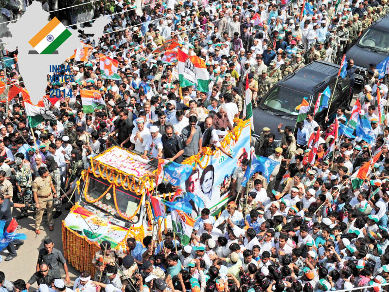 congress party vice president rahul gandhi gestures to supporters from atop a truck as he makes his way through the streets of varanasi during the final day of campaigning in the elections photo afp