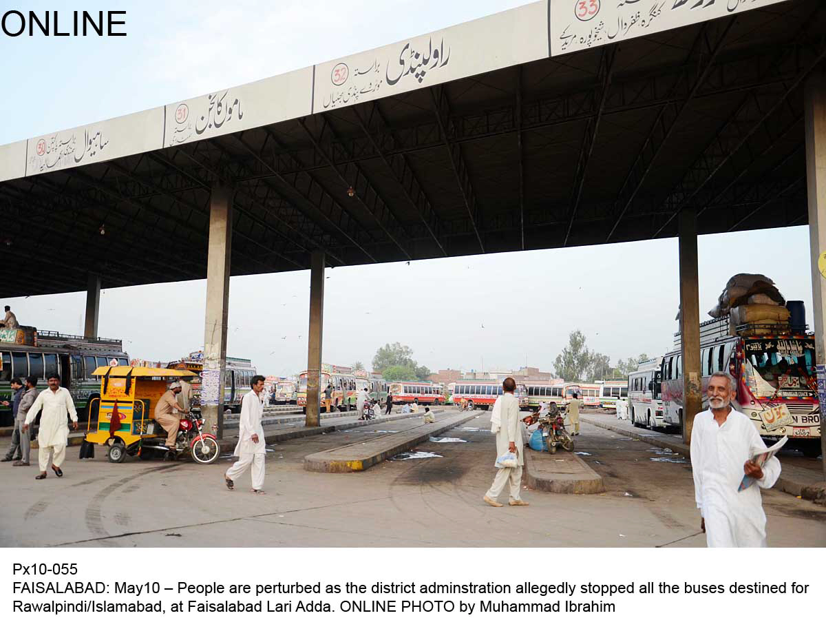 people stand at deserted bus stand in faisalabad on saturday photo online