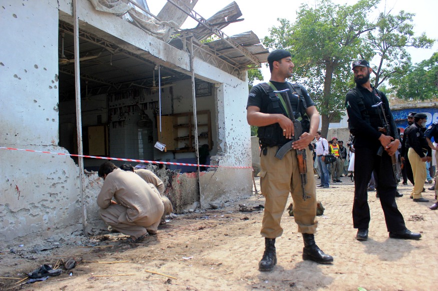 security officers stand guard near the blast site in peshawar photo muhammad iqbal express