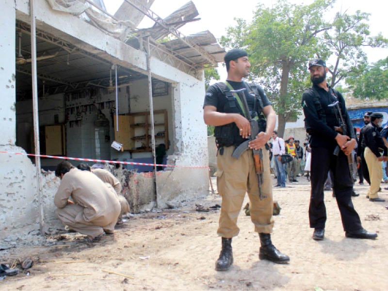 security officials stand guard at the blast site at tehmash stadium where a suicide bombing claimed at least four lives photo muhammad iqbal express