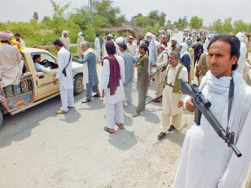 armed kaki tribesmen search vehicles and check the nics of passengers going in and out of thap thakthi khel on hawaid road bannu photo express