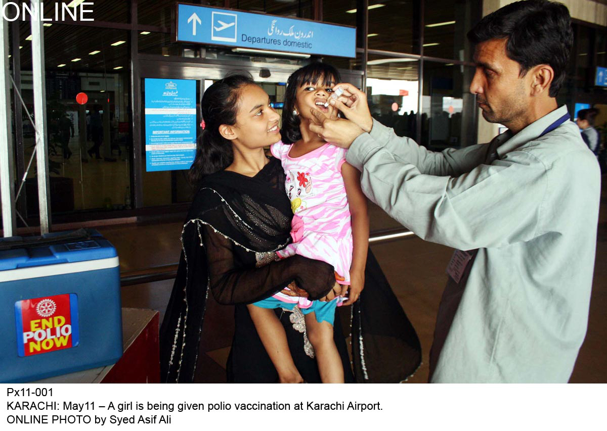 a health worker administers the polio vaccine to a child at the airport all pakistani travellers will be required to carry certification of polio vaccination for international trips from june 1 photo online