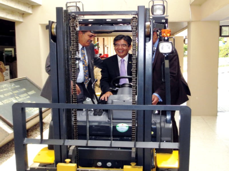 ambassador hiroshi inomata drives a fork lifter provided by his government to pims hospital during the medical equipment handing over ceremony at the hospital photo express