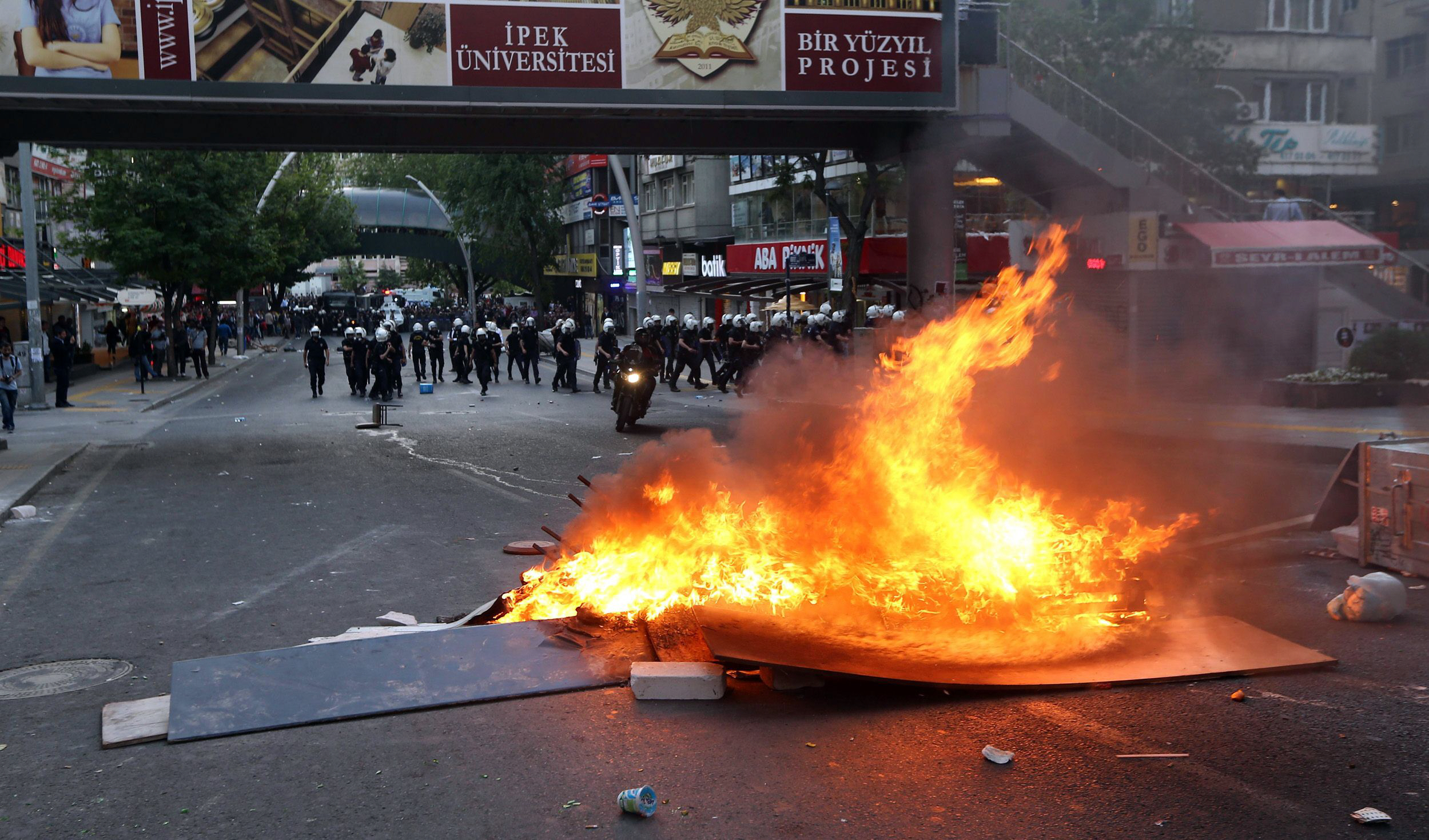 a fire is seen in a street of ankara on may 14 2014 during a demonstration gathering hundreds after more than 200 people were killed in an explosion at a mine police fired tear gas and water cannon when around 800 protesters shouting slogans against the government faced police intervention attempted to march from the middle east technical university to the energy ministry photo afp