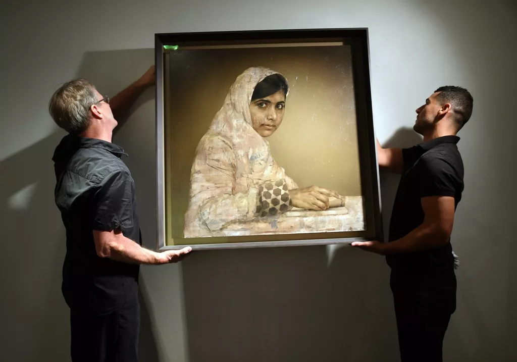 workers hang a painting by jonathan yeo titled quot girl reading malala yousafzai quot before the start of the auction may 14 2014 at christie 039 s afternoon session of post war and contemporary art in new york photo afp workers hang a painting by jonathan yeo titled quot girl reading malala yousafzai quot before the start of the auction may 14 2014 at christie 039 s afternoon session of post war and contemporary art in new york photo afp
