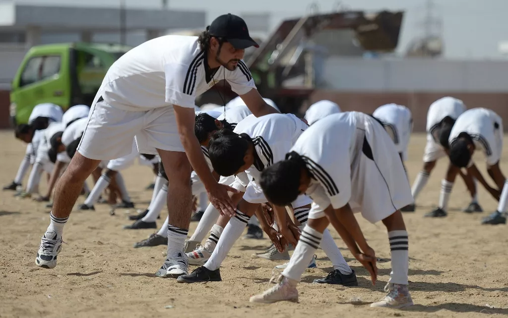 academy coach mohsin shah l instructs local youth as they participate in a training session at a local stadium in karachi photo afp academy coach mohsin shah l instructs local youth as they participate in a training session at a local stadium in karachi photo afp