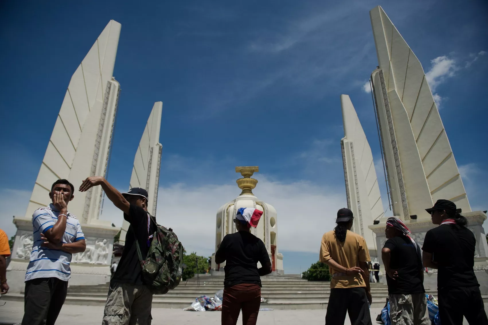 anti government protesters look at the site of a grenade and gun shot attacks at democracy monument in bangkok on may 15 2014 photo afp anti government protesters look at the site of a grenade and gun shot attacks at democracy monument in bangkok on may 15 2014 photo afp