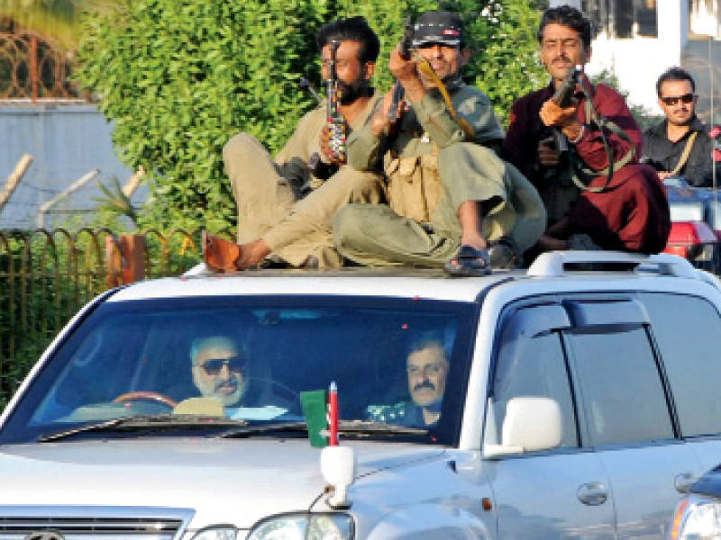 armed guards most of them without proper uniforms travelling with their weapons pointed at other vehicles have become a common sight in dha and clifton areas photo file