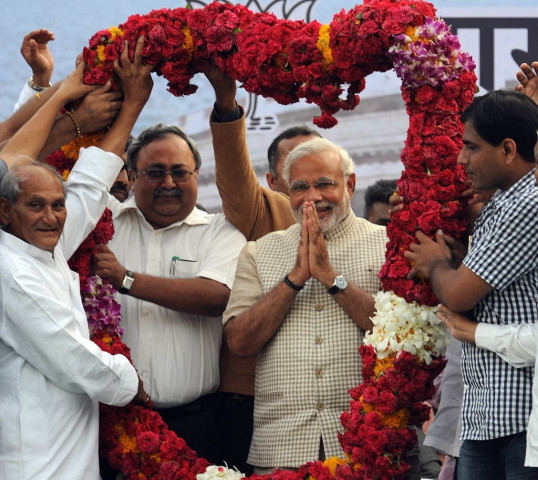 chief minister of western gujarat state and main opposition bharatiya janata party bjp prime ministerial candidate narendra modi 2nd r is garlanded as he arrives at a public rally after his victory in vadodara on may 16 2014 photo afp chief minister of western gujarat state and main opposition bharatiya janata party bjp prime ministerial candidate narendra modi 2nd r is garlanded as he arrives at a public rally after his victory in vadodara on may 16 2014 photo afp