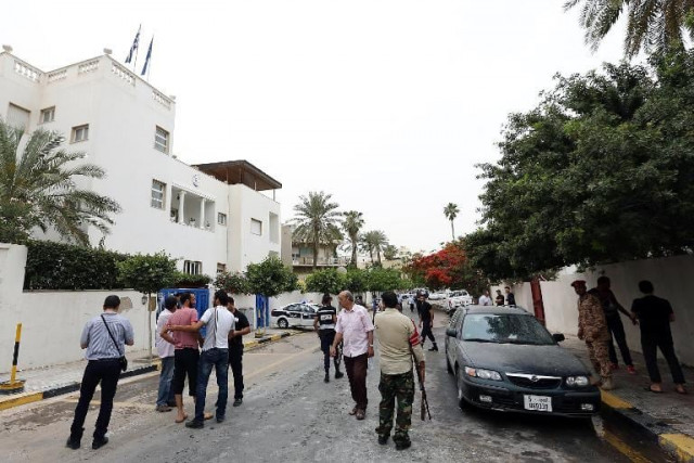 security forces and residents gather in the tripoli street housing the saudi embassy on may 18 2013 following a bomb blast photo afp security forces and residents gather in the tripoli street housing the saudi embassy on may 18 2013 following a bomb blast photo afp