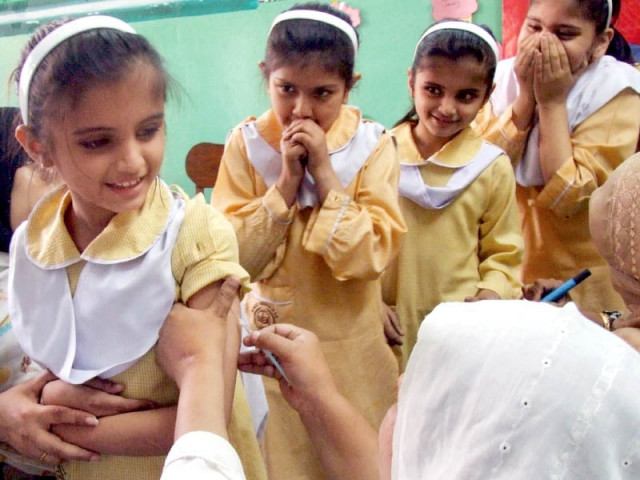 children line up in a school in peshawar to be vaccinated for measles during a country wide vaccination campaign photo inp children line up in a school in peshawar to be vaccinated for measles during a country wide vaccination campaign photo inp