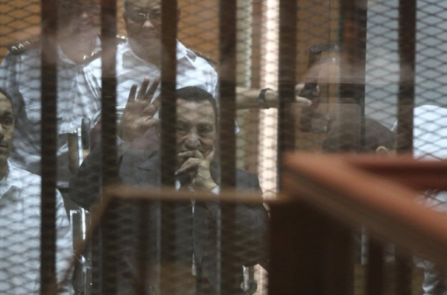 egypt 039 s deposed president hosni mubarak waves from behind the accused cage during his trial on may 21 2014 in cairo photo afp egypt 039 s deposed president hosni mubarak waves from behind the accused cage during his trial on may 21 2014 in cairo photo afp