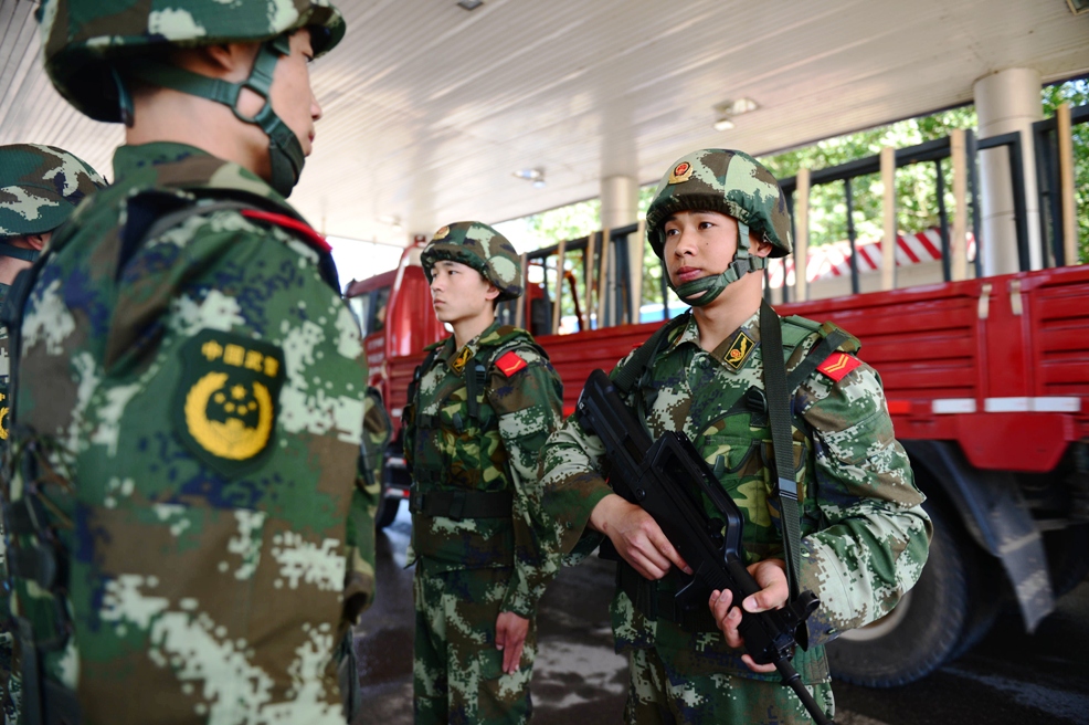 this picture taken on may 20 2014 shows chinese security personnel guarding a checkpoint along one of the highways leading into beijing photo afp