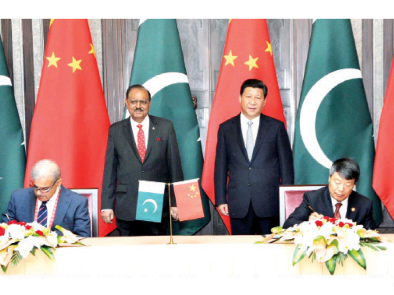 the pakistani and chinese presidents look on as chief minister shahbaz sharif signs the metro train agreement photo ppi