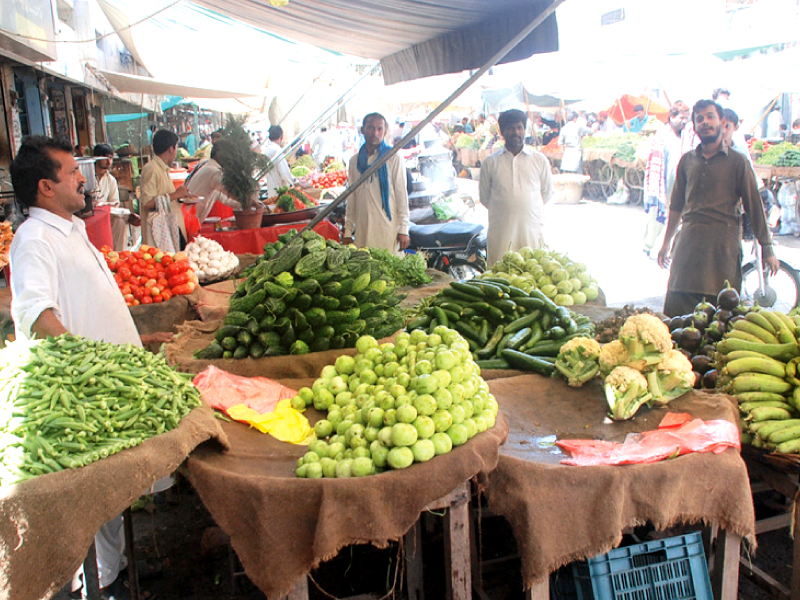 green grocers selling vegetables in rahim yar khan on thursday falling agricultural output is pushing up the prices of essential kitchen items photo sardar ahmed express