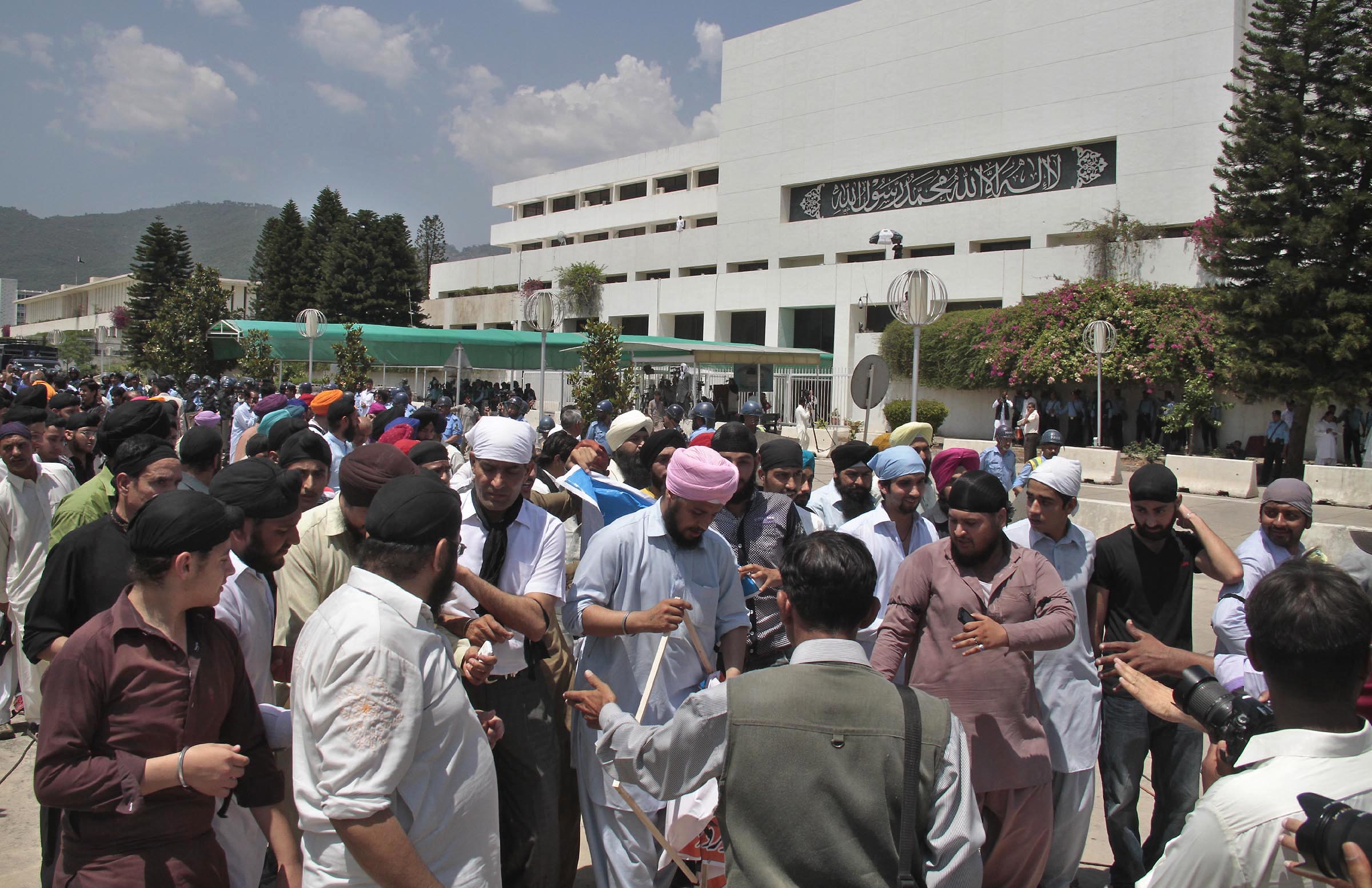 protesting sikh community members walk through the courtyard of the parliament house on friday after they had stormed its gate photo muhammad javed express