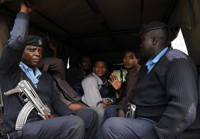 kenyan national security officers and arrested somali and ethiopian nationals sit in the back of a police truck as they are driven away from a centre on april 17 2014 in nairobi photo afp kenyan national security officers and arrested somali and ethiopian nationals sit in the back of a police truck as they are driven away from a centre on april 17 2014 in nairobi photo afp