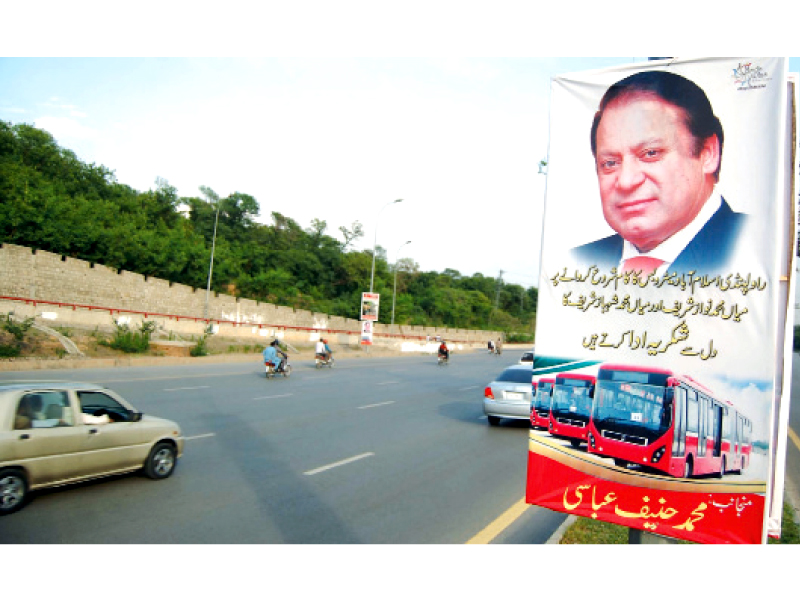 a streamer on a road side by a pml n politician appreciating the metro bus initiative photo muhammad javaid express