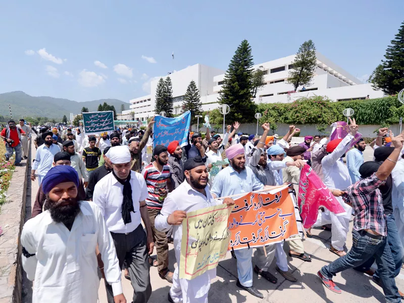 sikh protesters chant slogans as they protest outside the parliament house photo afp sikh protesters chant slogans as they protest outside the parliament house photo afp