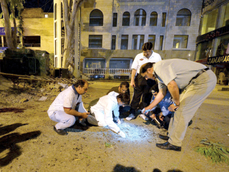 police investigate the site of the blast in super market photo afp