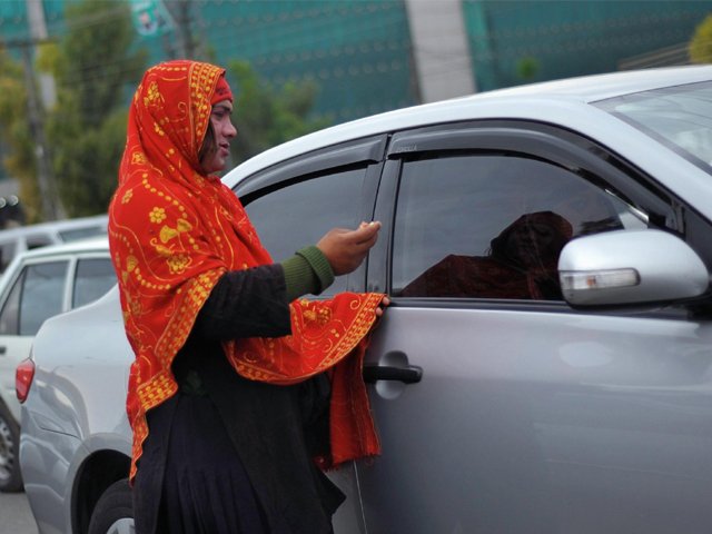 a transgender woman begs for alms from motorists at a traffic stop in rawalpindi outside islamabad pakistan on march 27 photo afp