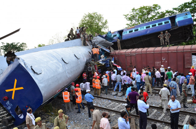 rescue workers and mangled train compartments are pictured after the gorakhdham express rammed into a goods train at chureb station in khalilabad some 700 kilometres 430 miles east of new delhi on may 26 2014 photo afp