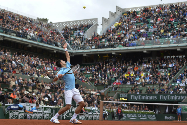 serbia 039 s novak djokovic serves to portugal 039 s joao sousa during their french tennis open first round match at the roland garros stadium in paris on may 26 2014 photo afp serbia 039 s novak djokovic serves to portugal 039 s joao sousa during their french tennis open first round match at the roland garros stadium in paris on may 26 2014 photo afp