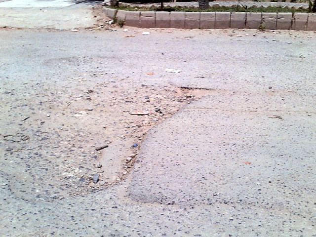 the potholed garbage lined service road photo sehrish wasif express the potholed garbage lined service road photo sehrish wasif express