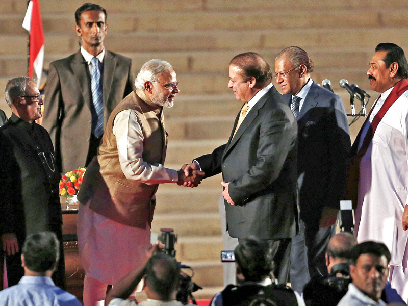 narendra modi shakes hands with nawaz sharif after taking oath as india s pm in new delhi photo reuters