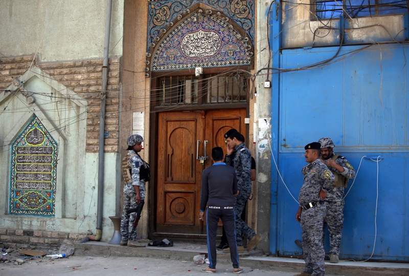 iraqi policemen inspect the site of a suicide bombing that killed at least 13 people outside a shia mosque in central baghdad on may 27 photo afp