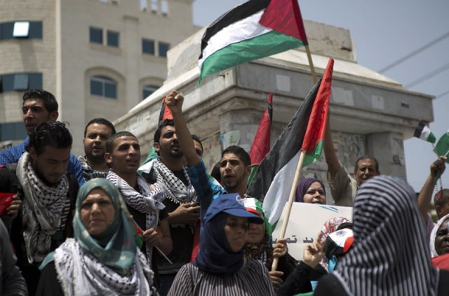 palestinian protesters chant slogans to speed up the implementation of the national reconciliation and the announcement of the formation of a national unity government during a rally in gaza city on may 27 2014 photo afp palestinian protesters chant slogans to speed up the implementation of the national reconciliation and the announcement of the formation of a national unity government during a rally in gaza city on may 27 2014 photo afp