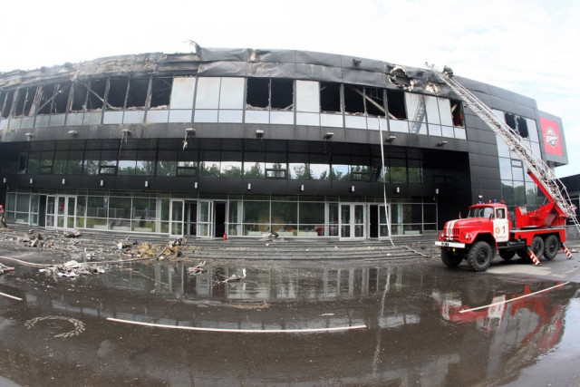 firemen work on the damaged druzhba hockey arena inthe eastern ukrainian city of donetsk burned by unknown armed men after they extinguished the fire on may 27 2014 photo afp firemen work on the damaged druzhba hockey arena inthe eastern ukrainian city of donetsk burned by unknown armed men after they extinguished the fire on may 27 2014 photo afp