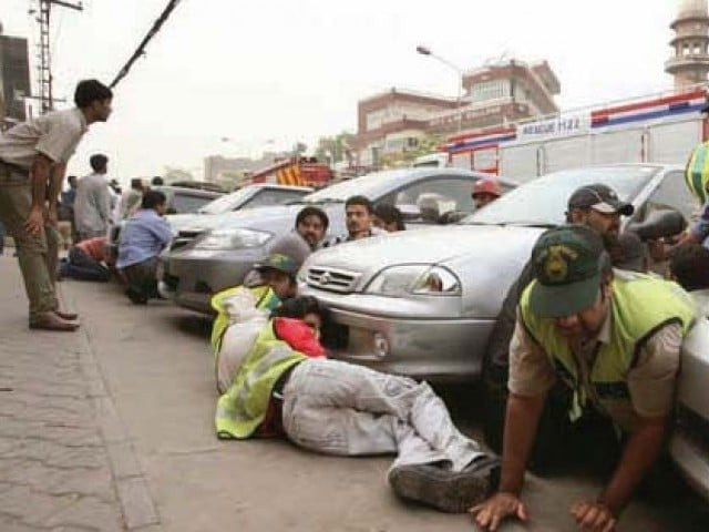 local residents and rescue workers take cover during an attack on an ahmadi worship centre in lahore s garhi shahu neighborhood on may 28 2010 photo file local residents and rescue workers take cover during an attack on an ahmadi worship centre in lahore s garhi shahu neighborhood on may 28 2010 photo file