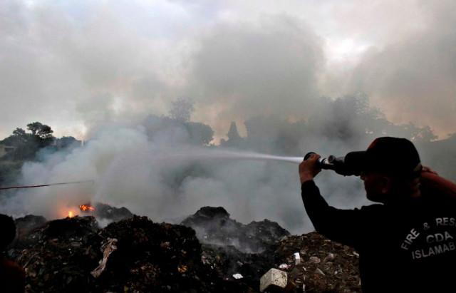 a fire fighter extinguishes the building on fire in islamabad photo muhammad javaid express a fire fighter extinguishes the building on fire in islamabad photo muhammad javaid express