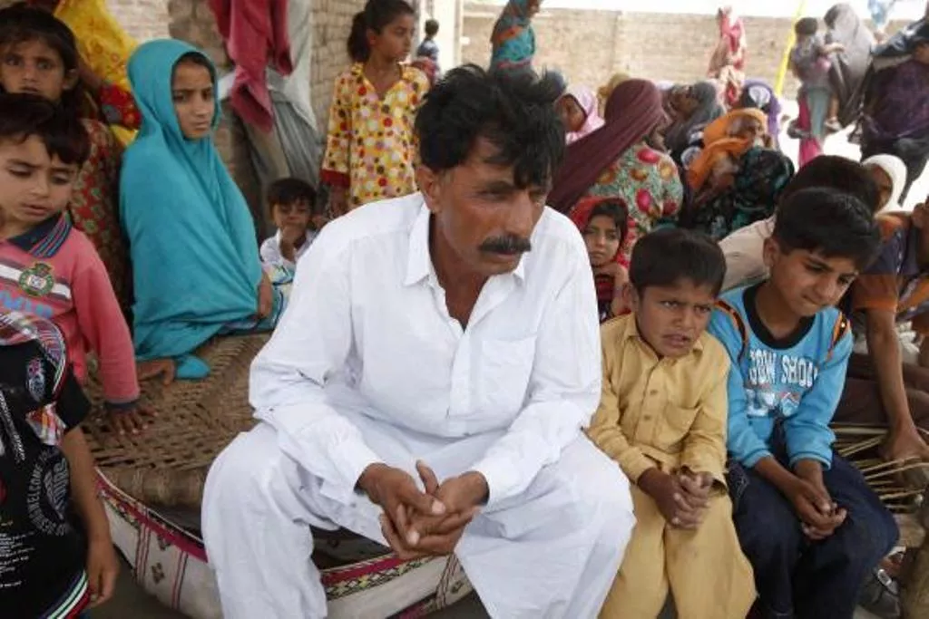muhammed iqbal 45 husband of the late farzana iqbal sits with his family members at his residence in a village in moza sial west of lahore may 30 2014 photo reuters muhammed iqbal 45 husband of the late farzana iqbal sits with his family members at his residence in a village in moza sial west of lahore may 30 2014 photo reuters