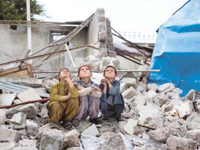 afghan children sitting on the remains of the pehli kiran school photo file express afghan children sitting on the remains of the pehli kiran school photo file express