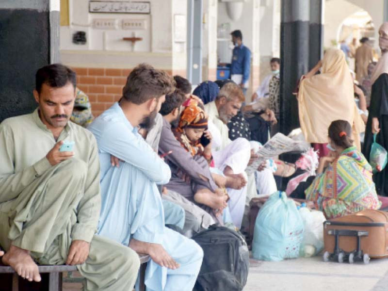 people wait for the resumption of train service at a platform of hyderabad railway station after a tragic accident near ghotki photo inp