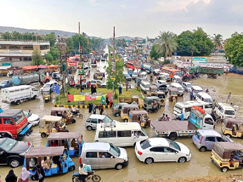 people are stuck in a traffic jam caused by inundated roads after rain in the city on thursday photo express