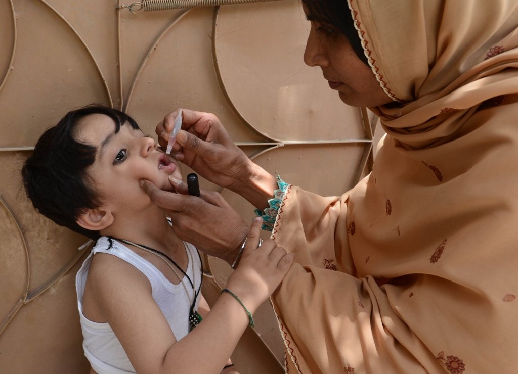 a polio worker administers polio vaccine drops to a child in quetta photo afp