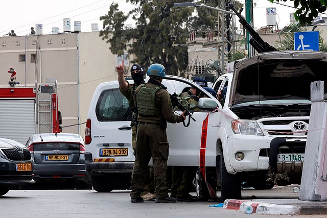 Israeli police inspect a car that has a Palestinian licence plate on it, following a mass-infiltration by Hamas gunmen from the Gaza Strip, in Sderot, southern Israel October 7, 2023: Reuters