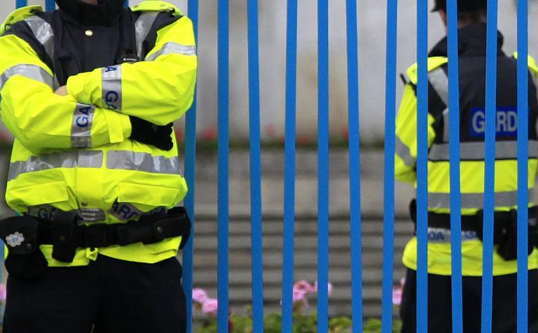 irish police stand guard outside a garden of remembrance in dublin on may 15 2011 photo afp