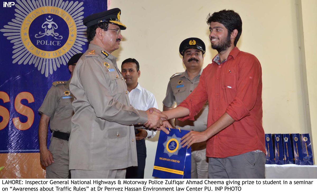 inspector general national highway police giving prize to student in a seminar photo inp