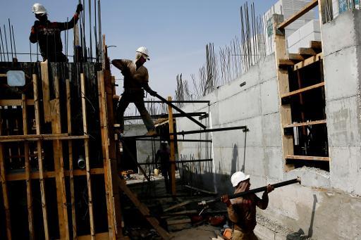 in this file photo palestinian labourers work on a construction site in ramat shlomo a jewish settlement in the mainly palestinian eastern sector of jerusalem photo afp