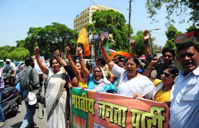 indian bharatiya janata party bjp supporters hold posters and chant slogans against the chief minister of the state of uttar pradesh akhilesh yadav as they take part in a protest against the gang rape and murder of two girls in the district of badaun in allahabad photo afp