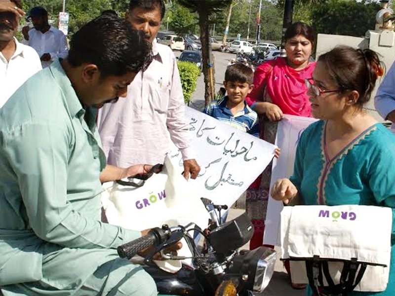 activist of an ngo distribute cloth bags to promote environment friendly practices at jinnah avenue photo express