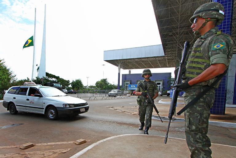 brazilian army soldiers stand guard at the puente de amistad in foz do iguacu parana during security operations to prevent weapons and explosives smuggling ahead of the upcoming brazil world cup photo afp